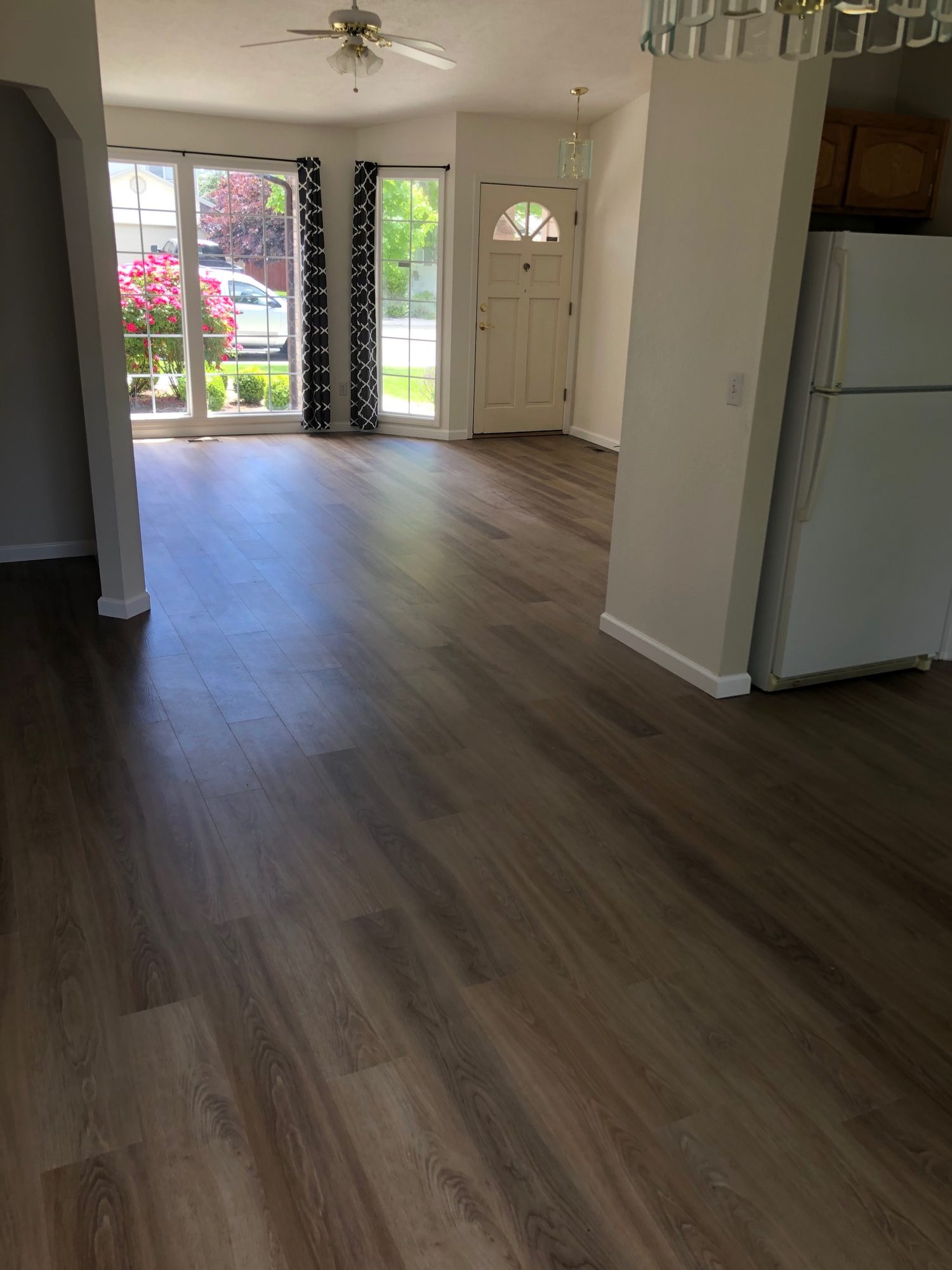 Dark luxury vinyl plank flooring installed through a kitchen