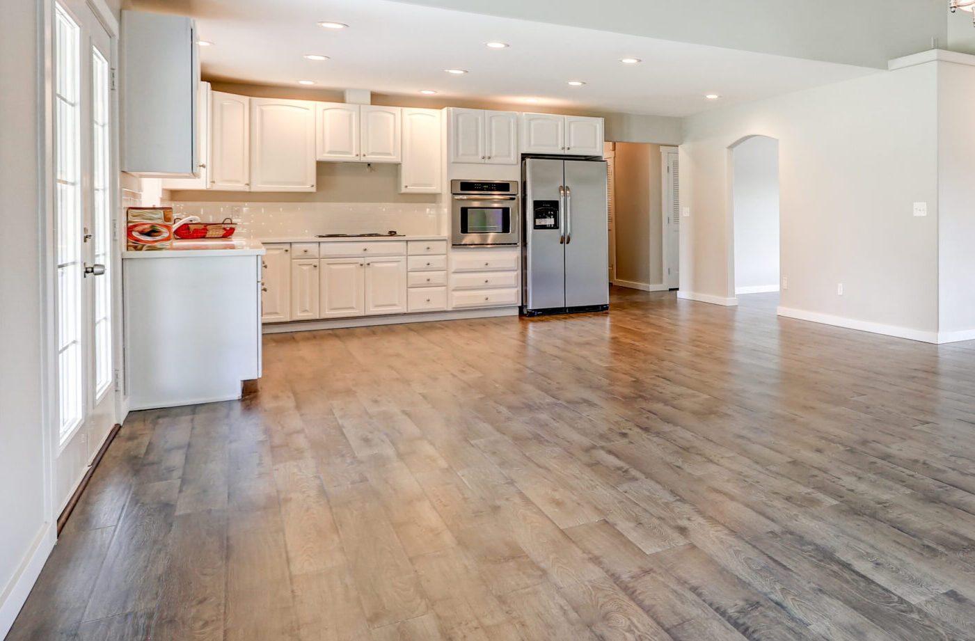 Light luxury vinyl plank flooring installed through a kitchen and dining area